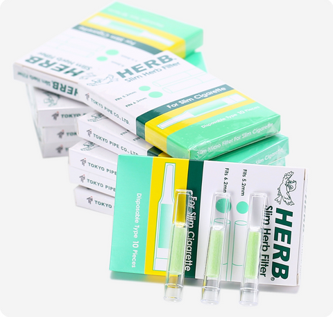 Herb cigarette packaging and filters on a white background