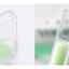 Two test tubes with green liquid against a blurred background
