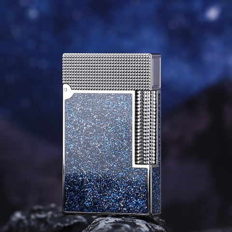 Metallic lighter with textured design on a dark blue gradient background